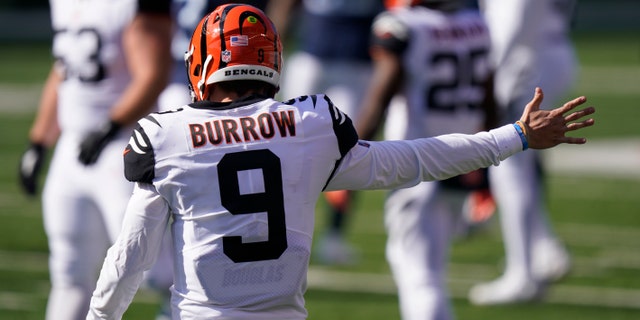 Cincinnati Bengals quarterback Joe Burrow (9) motions a first down during the first half of an NFL football game against the Tennessee Titans, Sunday, Nov. 1, 2020, in Cincinnati. (AP Photo/Bryan Woolston)