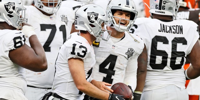 Las Vegas Raiders quarterback Derek Carr (4) and wide receiver Hunter Renfrow (13) celebrate after Renfrow scored a 4-yard touchdown during the second half of an NFL football game against the Cleveland Browns, Sunday, Nov. 1, 2020, in Cleveland. (AP Photo/Ron Schwane)