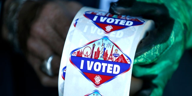 A poll worker displays "I Voted" stickers during the first day of early voting in Las Vegas.