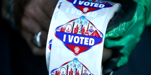 A poll worker displays "I Voted" stickers during the first day of early voting in Las Vegas.