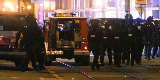 Police officers walk at the scene after gunshots were heard in Vienna.(Photo/Ronald Zak)