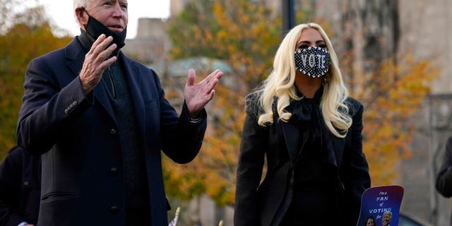 Democratic presidential candidate former Vice President Joe Biden stands with Lady Gaga at Schenley Plaza, Monday, Nov. 2, 2020, in Pittsburgh, Pa. (AP Photo/Andrew Harnik)