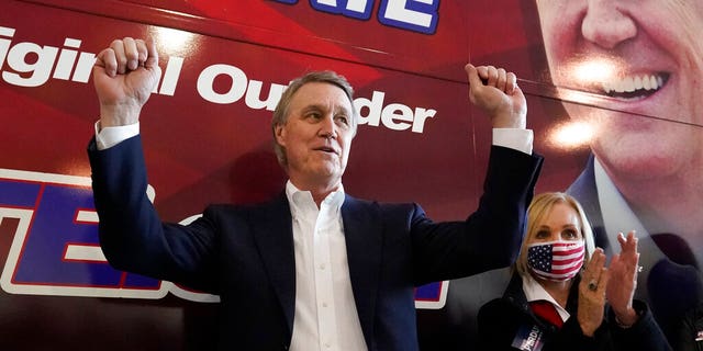 Republican candidate for Senate Sen. David Perdue and his wife Bonnie during a campaign stop at Peachtree Dekalb Airport Monday, Nov. 2, 2020, in Atlanta. (AP Photo/John Bazemore)