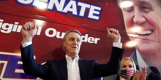 Republican candidate for Senate Sen. David Perdue and his wife Bonnie during a campaign stop at Peachtree Dekalb Airport Monday, Nov. 2, 2020, in Atlanta. (AP Photo/John Bazemore)