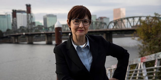 Portland Mayoral candidate Sarah Iannarone poses by the Willamette River. (AP Photo/Paula Bronstein, File)