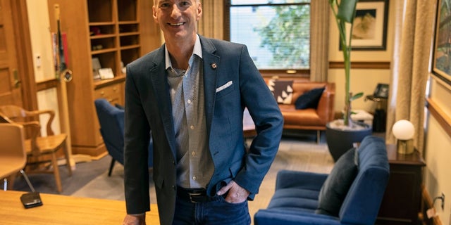 Mayor Ted Wheeler poses in a City Hall office in Portland, Ore. Wheeler won a second term after defeating challenger Sarah Iannarone on Tuesday. (AP Photo/Paula Bronstein, File)