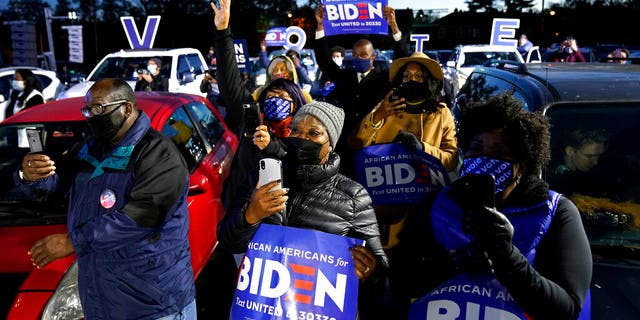 Supporter listen as Democratic presidential candidate former Vice President Joe Biden speaks at a drive-in campaign rally at Lexington Technology Park, Monday, Nov. 2, 2020, in Pittsburgh. (AP Photo/Andrew Harnik)