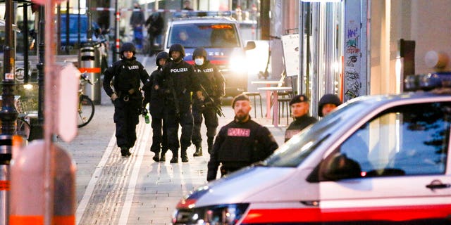 Following gunfire on people enjoying a last evening out before lockdown, police patrol at the scene in Vienna early Tuesday. (Photo/Ronald Zak)