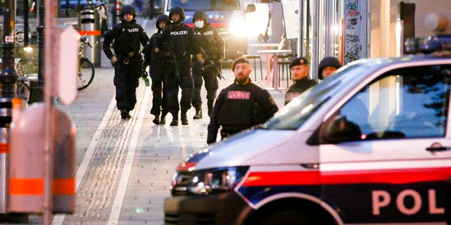 Following gunfire on people enjoying a last evening out before lockdown, police patrol at the scene in Vienna early Tuesday. (Photo/Ronald Zak)