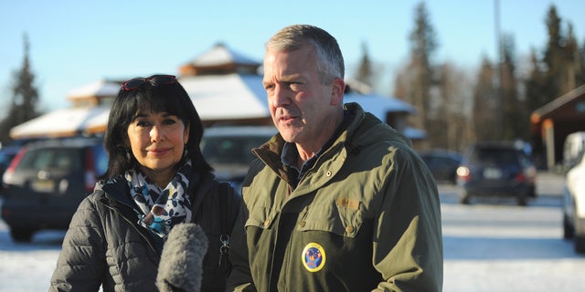 Incumbent Republican Sen. Dan Sullivan, left, with his wife Julie, speaks to the media after casting his ballot at the Alaska Zoo Tuesday, Nov. 3, 2020, in Anchorage, Alaska. (AP Photo/Michael Dinneen)