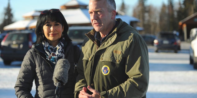 Incumbent Republican Sen. Dan Sullivan, left, with his wife Julie, speaks to the media after casting his ballot at the Alaska Zoo Tuesday, Nov. 3, 2020 in Anchorage, Alaska. (AP Photo/Michael Dinneen)
