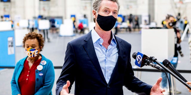 Gov. Gavin Newsom discusses the 2020 election while visiting the Golden State Warriors training facility, which is serving as a polling location, on Nov. 3, in Oakland, Calif.  (AP Photo/Noah Berger)