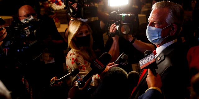 Republican U.S. Senate candidate Tommy Tuberville talks with media as he arrives for the watch party at the Renaissance Hotel on Tuesday, Nov. 3, 2020, in Montgomery, Ala. (Associated Press)