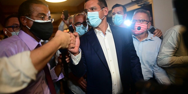 Pedro Pierluisi, gubernatorial candidate with the New Progressive Party (PNP), arrives at Vivo Beach Club to celebrate a slim lead of the pro-statehood party in the Puerto Rican general elections, in Carolina, Puerto Rico, Tuesday, Nov. 3, 2020. Pierluisi briefly served as governor following last year's massive protests that led to the resignation of former Gov. Ricardo Rosselló. (AP Photo/Carlos Giusti)