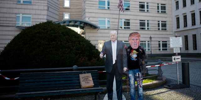 Gerd Lindner, who said he's a huge fan of US President Donald Trump, poses near a paper mache effigy of Trump with a Trump mask to support the president a day after the election in the front of the United States embassy in Berlin, Germany, Wednesday, Nov. 4, 2020. (Photo/Markus Schreiber)