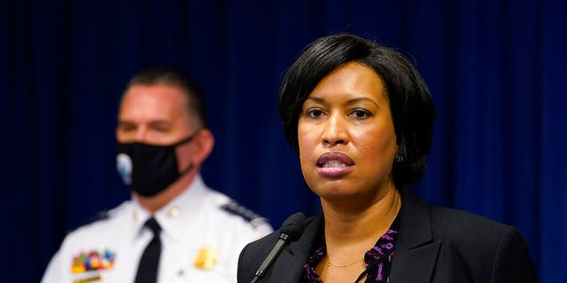 District of Columbia Mayor Muriel Bowser, right, standing next to Metropolitan Police Department chief Peter Newsham, left, speaks during a news conference in Washington, Wednesday, Nov. 4, 2020. (AP Photo/Susan Walsh)