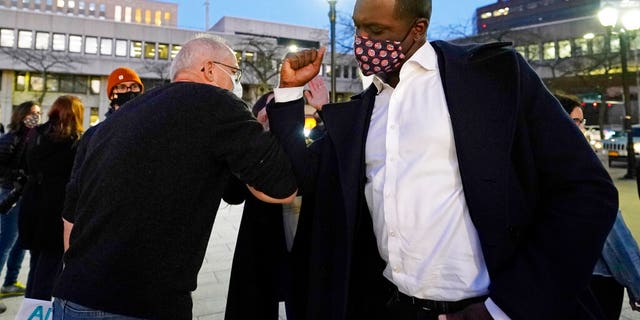 Rep.-elect Mondaire Jones, right, bumps elbows with a supporter after addressing a Protect the Results rally, Wednesday, Nov. 4, 2020, in front of the Westchester County Courthouse in White Plains, N.Y. (AP Photo/Kathy Willens)