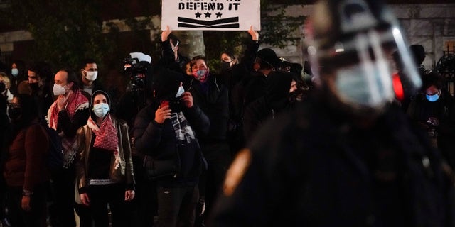 Demonstrators shout at New York Police officers as they protest in Washington Square Park, Wednesday, Nov. 4, 2020, in New York. (AP Photo/Seth Wenig)