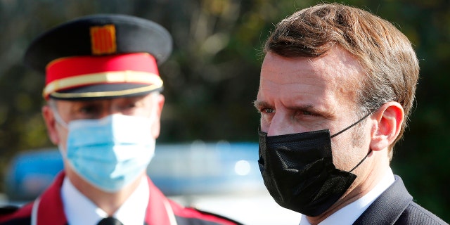 French President Emmanuel Macron arrives at the 'Centre de cooperation policiere et douaniere' (Franco-Spanish Police and Customs Cooperation Center) during a visit on the strengthening border controls at the crossing between Spain and France, at Le Perthus, France, Thursday, Nov. 5, 2020. (Guillaume Horcajuelo, Pool via AP)