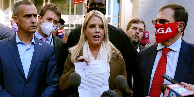 Former Florida Attorney General Pam Bondi displays a court order granting President Trump's campaign more access to vote counting operations at the Pennsylvania Convention Center, Thursday, Nov. 5, 2020, in Philadelphia. (AP Photo/Matt Slocum)
