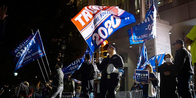 Supporters of President Trump stand outside the Pennsylvania Convention Center where votes are being counted, Thursday, Nov. 5, 2020, in Philadelphia, following Tuesday's election. (AP Photo/Matt Slocum)