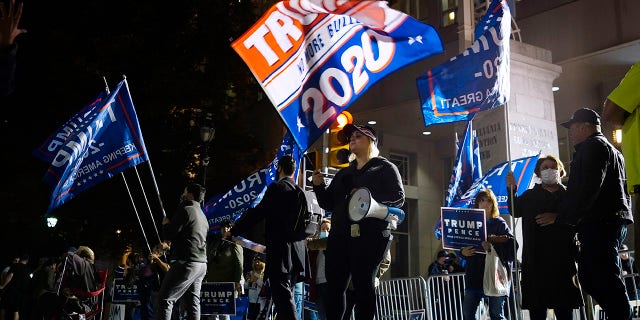 Supporters of President Trump stand outside the Pennsylvania Convention Center where votes are being counted, Thursday, Nov. 5, 2020, in Philadelphia, following Tuesday's election. (AP Photo/Matt Slocum)