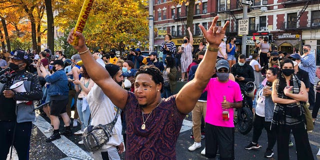 People fill the streets in Harlem after former vice president and Democratic presidential candidate Joe Biden was announced as the winner over Pres. Donald Trump Nov. 7, in New York. (AP Photo/Mark Lennihan)