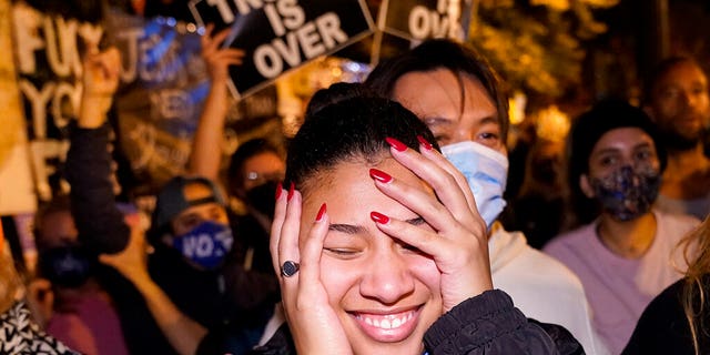 Angelique McKenna reacts to President-elect Joe Biden's victory speech while listening at Black Lives Matter Plaza,  Nov. 7, in Washington. (AP Photo/Jacquelyn Martin)