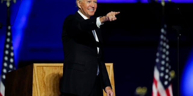 President-elect Joe Biden points to the crowd as he stands on stage after speaking Saturday, Nov. 7, 2020, in Wilmington, Del. (AP Photo/Andrew Harnik)