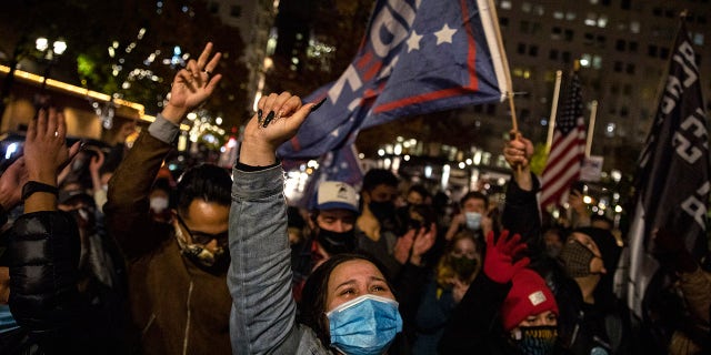 Brittney Hernandez celebrates Joe Biden's win in the presidential election, Saturday, Nov. 7, 2020, in Portland, Ore. (AP Photo/Paula Bronstein)