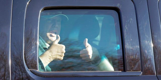 President Trump gives two thumbs up to supporters as he departs after playing golf at the Trump National Golf Club in Sterling Va., Sunday Nov. 8, 2020. (AP Photo/Steve Helber)