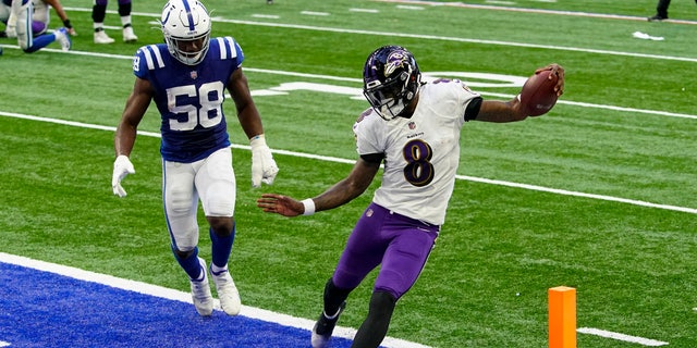 Baltimore Ravens quarterback Lamar Jackson (8) runs in for a touchdown in front of Indianapolis Colts inside linebacker Bobby Okereke (58) in the second half of an NFL football game in Indianapolis, Sunday, Nov. 8, 2020. (AP Photo/AJ Mast)