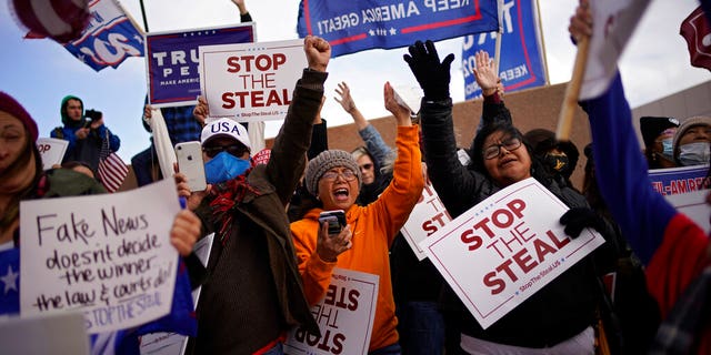 Supporters of President Donald Trump pray as they protest the election outside the Clark County Elections Department, Sunday, November 8, 2020, in North Las Vegas.