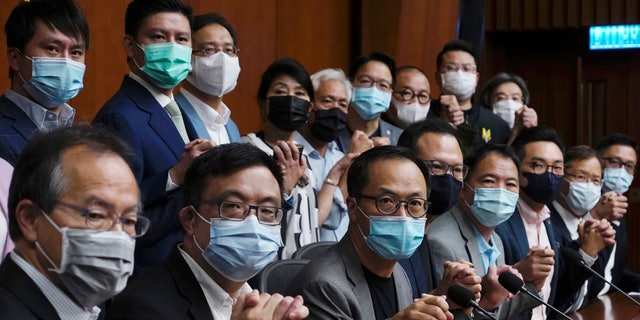 Hong Kong's pro-democracy legislators pose a picture before a press conference at the Legislative Council in Hong Kong, Monday, Nov. 9, 2020. (AP Photo/Vincent Yu)