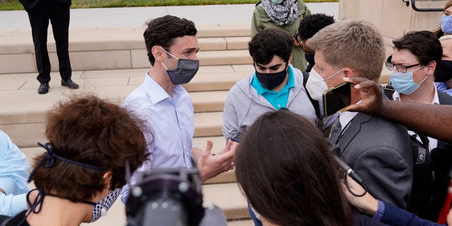 Democratic candidate for U.S. Senate Jon Ossoff speaks to reporters after a news conference Tuesday, Nov. 10, 2020, in Atlanta. (AP Photo/John Bazemore)