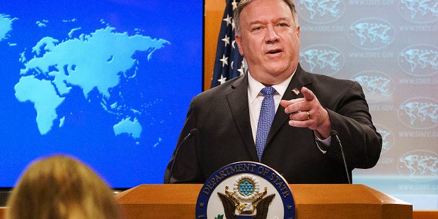 Then-Secretary of State Mike Pompeo gestures toward a reporter while speaking about the counting of votes in the U.S. election during a briefing to the media, Tuesday, Nov. 10, 2020, at the State Department in Washington. (AP Photo/Jacquelyn Martin, Pool)