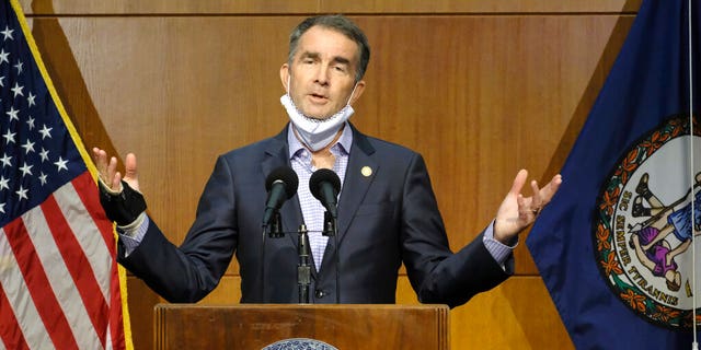 Virginia Gov. Ralph Northam answers a reporter's question dealing with the state's COVID-19 updates during a press conference at the Patrick Henry Building in Richmond, Va., Tuesday, Nov. 10, 2020. (Bob Brown/Richmond Times-Dispatch via AP)