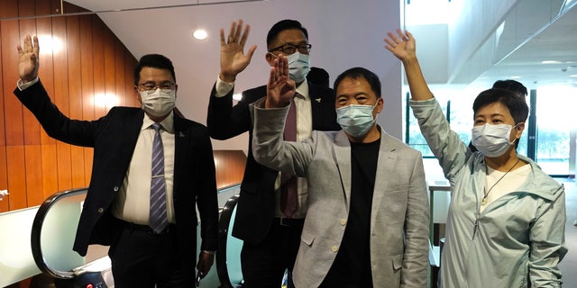 Pro-democracy legislators, from right, Wong Pik Wan, Wu Chi Wai, Lam Cheuk-ting and Yoon Siu Kin wave after handing in their resignations at Legislative Council in Hong Kong on Thursday, Nov. 12, 2020. (AP Photo/Vincent Yu)