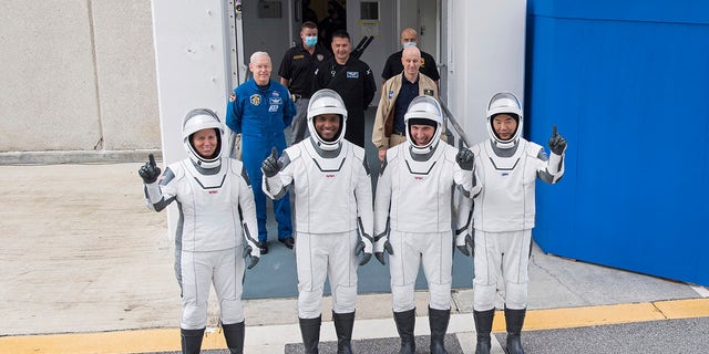 NASA astronauts, left to right, Shannon Walker, Victor Glover, Mike Hopkins and Japan Aerospace Exploration Agency (JAXA) astronaut Soichi Noguchi, right, dressed in SpaceX space suits, stop to pose for a photo exiting Neil A. Armstrong's operations and controls.  The building will depart for Launch Complex 39A during a dress rehearsal Thursday, November 12, 2020 at NASA's Kennedy Space Center in Cape Canaveral, Florida.