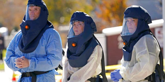 Salt Lake County Health Department public health nurses look on during coronavirus testing outside the Salt Lake County Health Department Thursday. (AP Photo/Rick Bowmer)