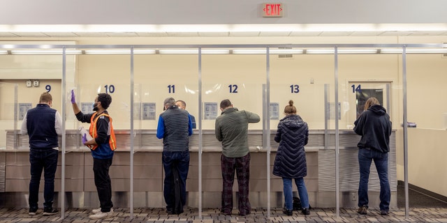 People get tested at the new saliva COVID-19 testing site at the Minneapolis-St. Paul International Airport, Thursday, Nov. 12, 2020.(Elizabeth Flores/Star Tribune via AP)