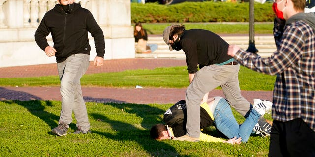 A supporter of President Donald Trump is attacked during a pro-Trump march Saturday Nov. 14, 2020, in Washington. (AP Photo/Jacquelyn Martin)