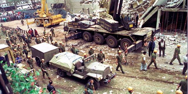 Israeli soldiers bring in heavy lifting equipment to the wreckage of the Ufundi House, adjacent to the U.S. Embassy in Nairobi on Aug. 9, 1998. The United States and Israel worked together to track and kill Abu Mohammed al-Masri, a senior Al Qaeda operative in Iran earlier this year, a bold intelligence operation by the two allied nations that came as the Trump administration was ramping up pressure on Tehran. (AP Photo/Sayyid Azim, File)