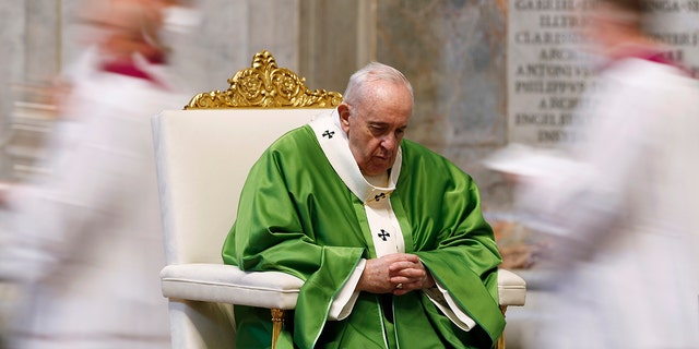 Pope Francis sits during a Mass marking the Roman Catholic Church's World Day of the Poor, at St. Peter's Basilica at the Vatican Sunday, Nov. 15, 2020.