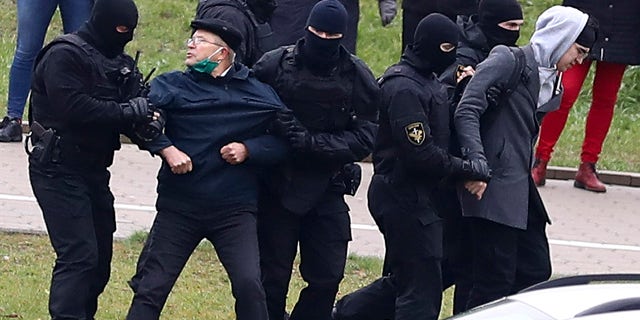 Belarusian riot police detain demonstrators during an opposition rally to protest the official presidential election results in Minsk, Belarus, Sunday, Nov. 15, 2020. (AP Photo)