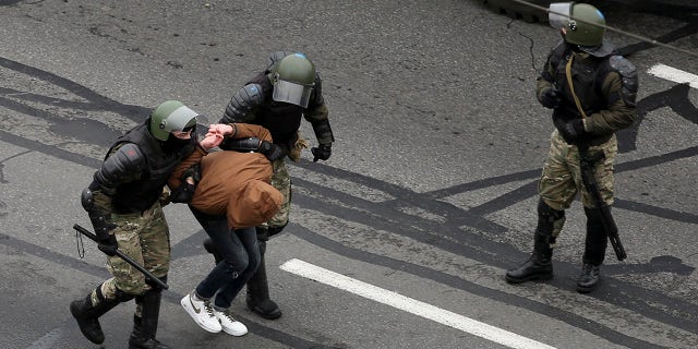 Belarusian riot police a demonstrator during an opposition rally to protest the official presidential election results in Minsk, Belarus, Sunday, Nov. 15, 2020. (AP Photo)