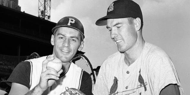 In this Aug. 11, 1960, file photo, shortstop Dick Groat, left, of the Pittsburgh Pirates, and pitcher Lindy McDaniel, of the St. Louis Cardinals, talk at Forbes Field in Pittsburgh. (AP Photo/File)