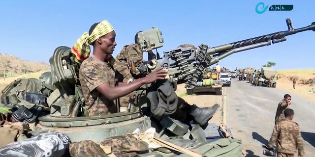 This image made from undated video released by the state-owned Ethiopian News Agency on Monday, Nov. 16, 2020 shows Ethiopian military in an armored personnel carrier, on a road in an area near the border of the Tigray and Amhara regions of Ethiopia. (Ethiopian News Agency via AP)