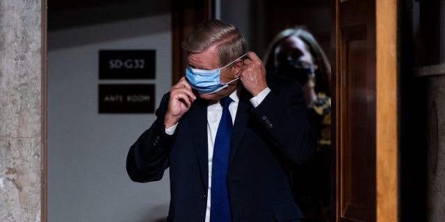 Congress a microcosm of America's coronavirus struggle 1 Sen. Lindsey Graham, R-S.C., puts on his face mask as he arrives for a Senate Judiciary Committee hearing on Facebook and Twitter's actions around the closely contested election on Tuesday, Nov. 17, 2020, in Washington.. (Bill Clark/Pool via AP)