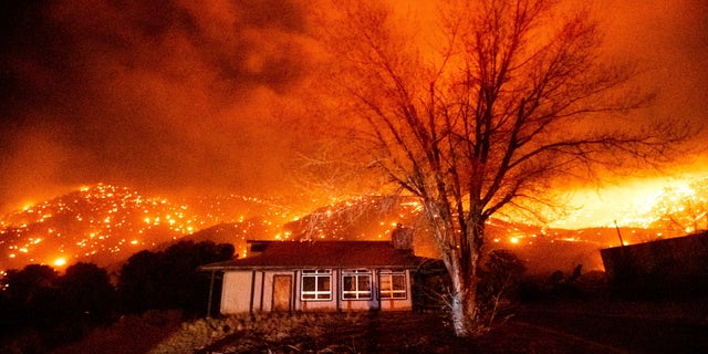 The embers are burning along the hillsides as Mountain View Fire erupts on Tuesday, November 17, 2020, in the Walker community of Mono County, California. (AP Photo / Noah Berger)